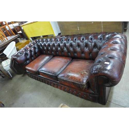 286 - A burgundy leather Chesterfield settee