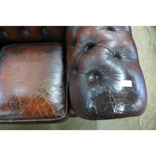 286 - A burgundy leather Chesterfield settee