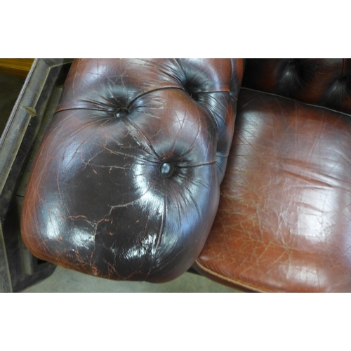 286 - A burgundy leather Chesterfield settee