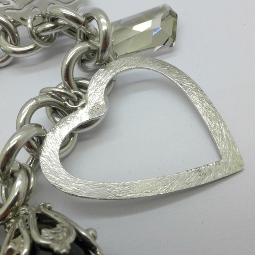 1016 - A silver charm bracelet, 55.1g