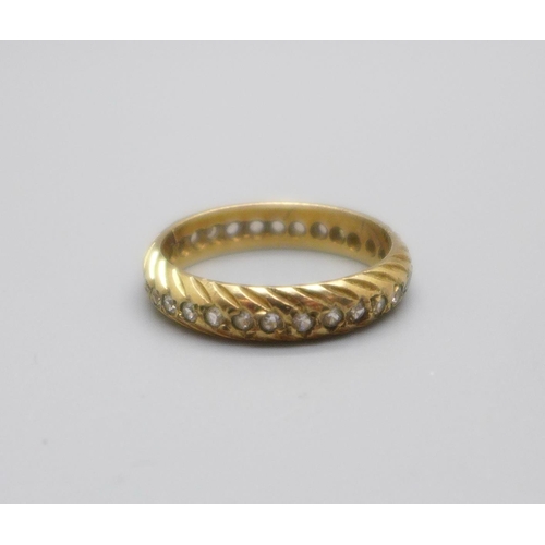 1035 - A yellow metal eternity ring, set with white stones, 2.5g, M