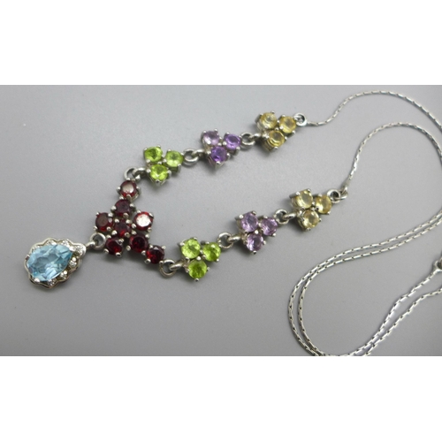 1061 - A silver necklace set with garnet, amethyst, peridot and blue topaz