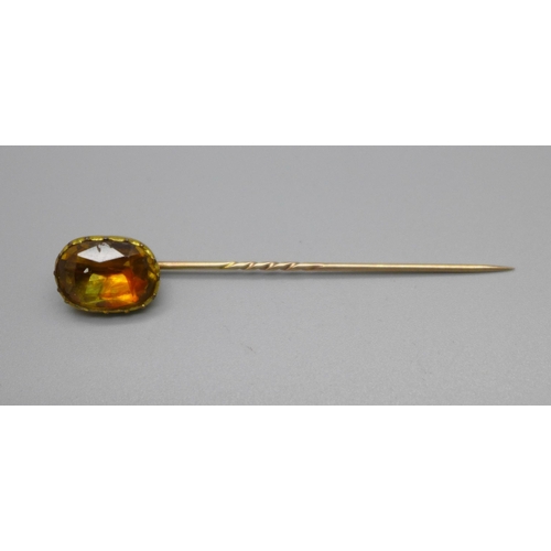 1065 - A Victorian yellow metal stick pin set with yellow stone in original fitted box