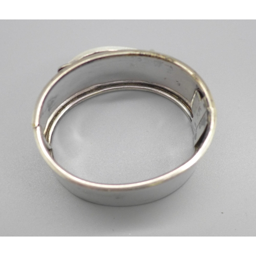 1094 - A white metal bangle in the form of a buckle, 47.3g