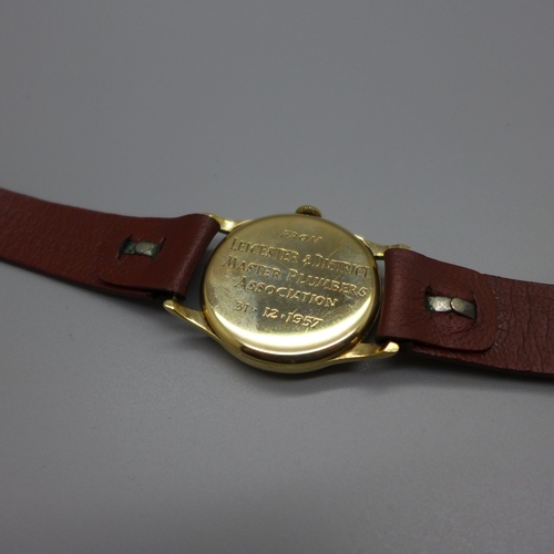 1113 - A 9ct gold Record wristwatch, the case back bears inscription dated 1957, 31mm case