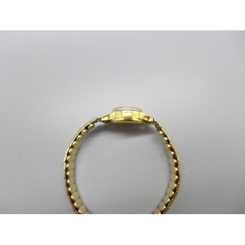 1125 - A lady's 18ct gold cased MuDu wristwatch on an expanding rolled gold bracelet strap