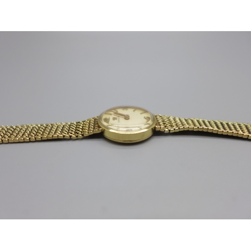 1129 - A lady's 9ct gold Omega wristwatch with integrated bracelet strap, total weight with movement 21.7g