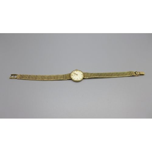 1129 - A lady's 9ct gold Omega wristwatch with integrated bracelet strap, total weight with movement 21.7g