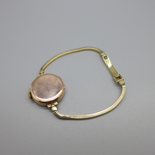 1130 - A lady's 9ct gold Buren wristwatch on a 9ct gold bracelet strap, London 1923, total weight with move... 