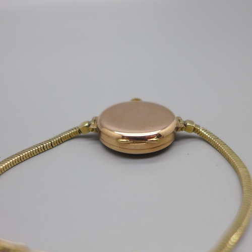 1130 - A lady's 9ct gold Buren wristwatch on a 9ct gold bracelet strap, London 1923, total weight with move... 