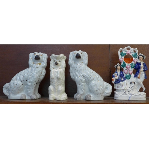 605 - A pair of Staffordshire dogs, a similar jug and a flatback figure/watch holder