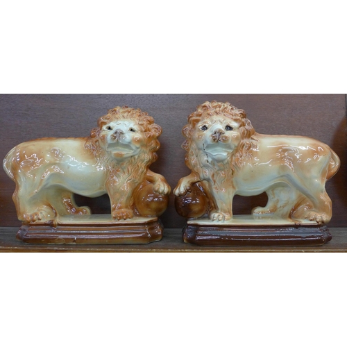 608 - A pair of Staffordshire lions, height 30cm