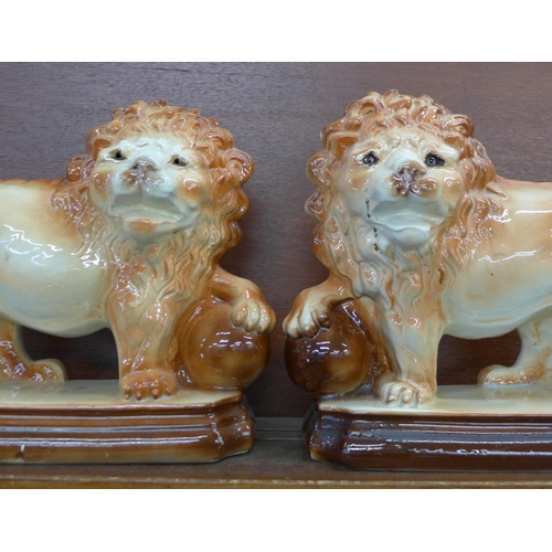 608 - A pair of Staffordshire lions, height 30cm