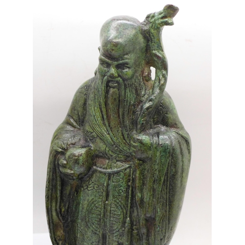 625 - A Chinese bronze figure of a sage and a bronze monkey candlestick, figure 22cm