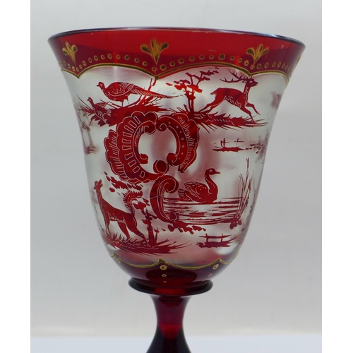 639 - A ruby glass goblet with shooting scenes, 16.5cm