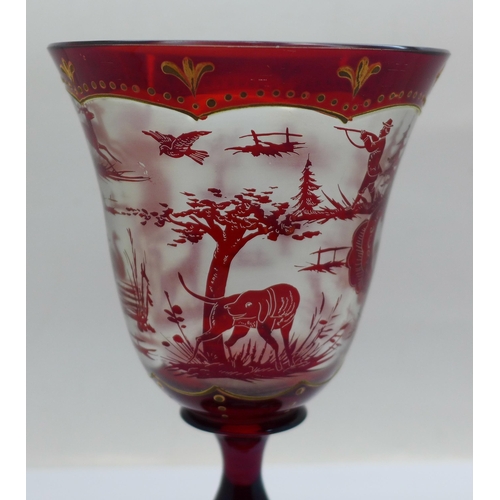 639 - A ruby glass goblet with shooting scenes, 16.5cm