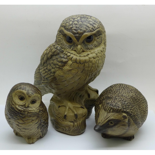 657 - Two Poole pottery owls, the largest signed, a Poole hedgehog and a pig money bank