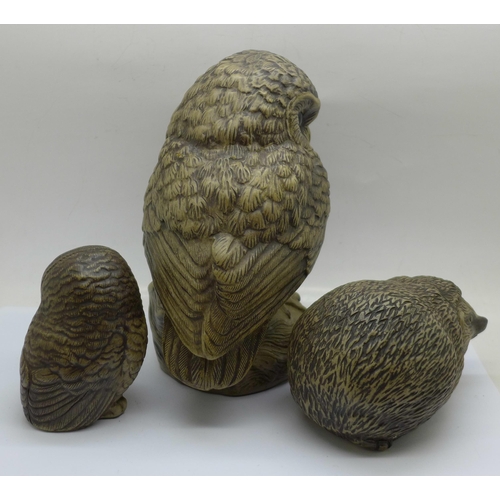 657 - Two Poole pottery owls, the largest signed, a Poole hedgehog and a pig money bank