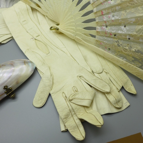 663 - An antique shell purse, an Edwardian lace fan, a headband and a pair of gloves