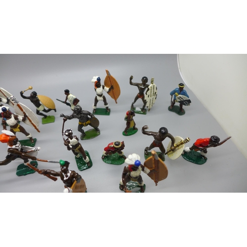 665 - A collection of metal Zulu warrior figures