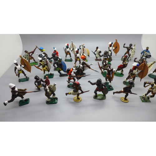 665 - A collection of metal Zulu warrior figures