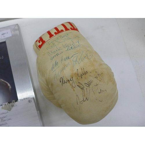 694 - A boxing glove with ten signatures of boxers from 1980's including Frank Bruno and a picture of Evan... 