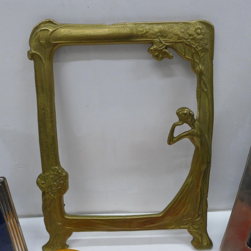 734 - An Art Nouveau style brass photograph frame, two silver plated photograph frames and three glass ite... 