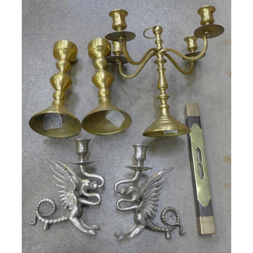 756 - A brass candelabra, two brass candlesticks, two metal candlesticks in the form of dragons and a wood... 