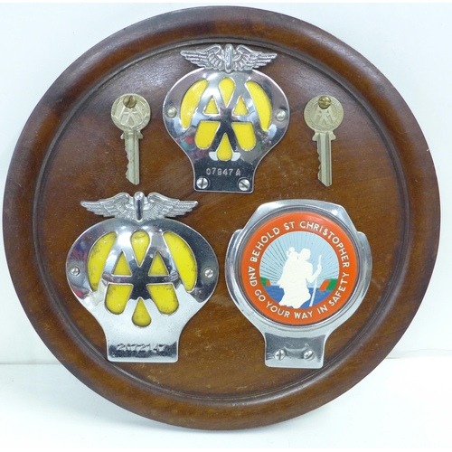 821 - A mounted collection of AA badges and a St. Christopher badge