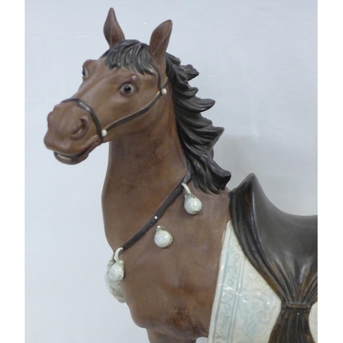 839 - A Chinese pottery horse, marked