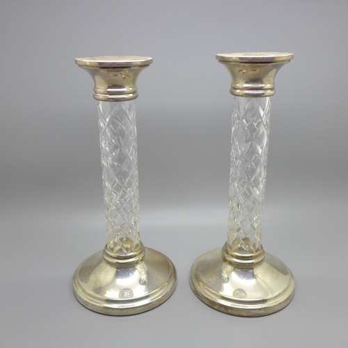 857 - A pair of silver and cut glass candlesticks, 22cm