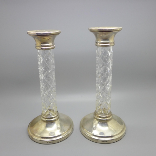 857 - A pair of silver and cut glass candlesticks, 22cm