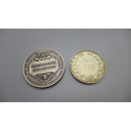 894 - Two silver medallions, 128g