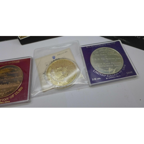 901 - A collection of commemorative coins including one silver 1973 Royal wedding coins, (folders not comp... 