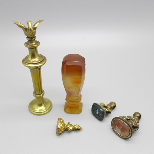 920 - An agate seal, a brass seal with swan finial and three seal fobs