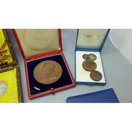 944 - A case with eight 1946 half-crowns, a Queen Victoria commemorative medallion and other coins