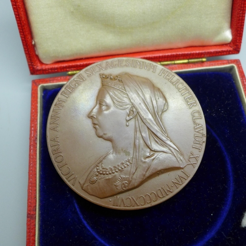 944 - A case with eight 1946 half-crowns, a Queen Victoria commemorative medallion and other coins