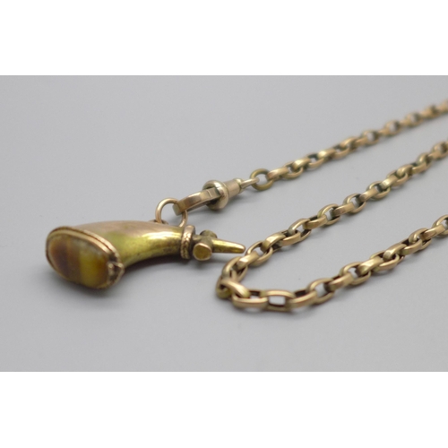 955 - A yellow metal powder flask fob set with tigers eye on a 9ct gold Albert chain, 10.1g