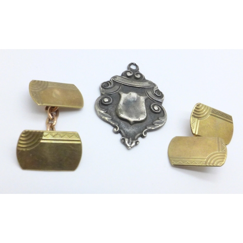 966 - A pair of 9ct gold cufflinks, 4.6g and a silver fob