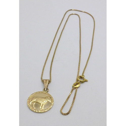 973 - A 14ct gold chain and a yellow metal pendant, 5.3g