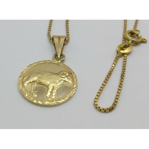 973 - A 14ct gold chain and a yellow metal pendant, 5.3g