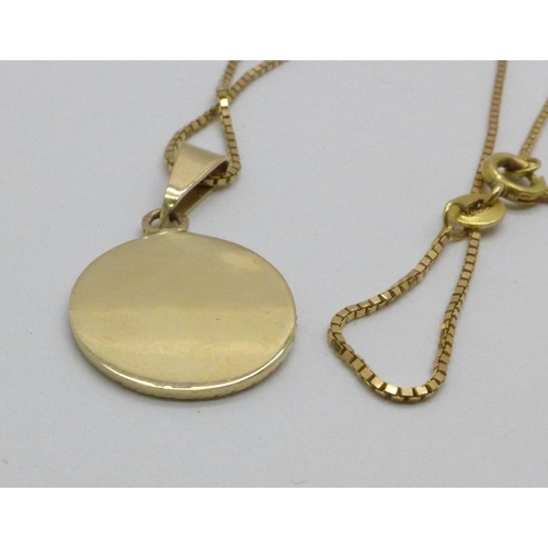 973 - A 14ct gold chain and a yellow metal pendant, 5.3g