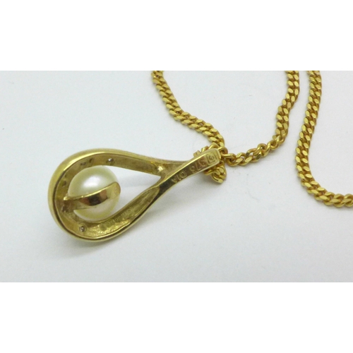 974 - A 9ct gold, diamond and cultured pearl pendant on a 9ct gold chain, 3.3g