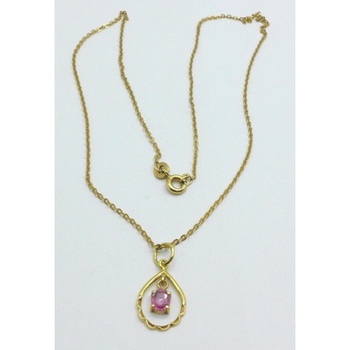 979 - A 14ct yellow gold and pink stone pendant on yellow metal chain, chain marked 333, 2.0g