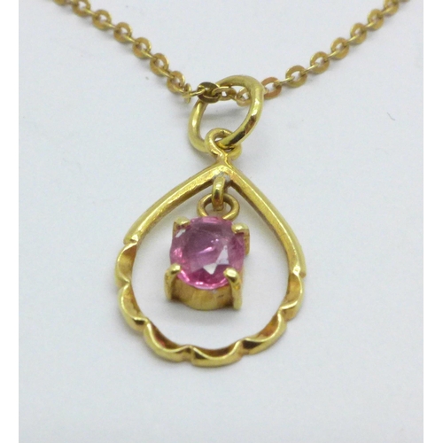 979 - A 14ct yellow gold and pink stone pendant on yellow metal chain, chain marked 333, 2.0g