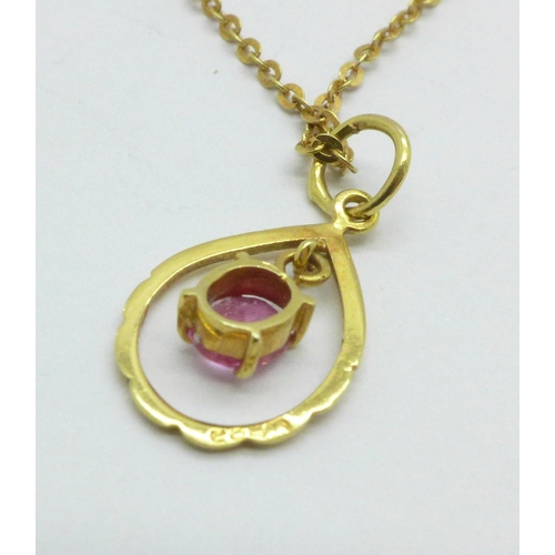 979 - A 14ct yellow gold and pink stone pendant on yellow metal chain, chain marked 333, 2.0g