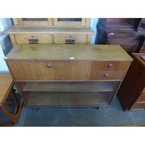 132 - An Avalon teak bookcase, two teak coffee tables, a nest of two tables and another