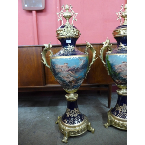 14 - A pair of large Sevres style cobalt blue porcelain and gilt metal two handled garnitures, 107cms h