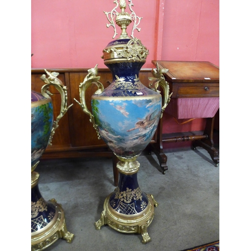 14 - A pair of large Sevres style cobalt blue porcelain and gilt metal two handled garnitures, 107cms h