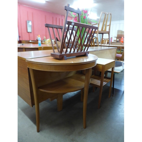 146 - A teak demi lune hall table, a teak magazine rack and one other